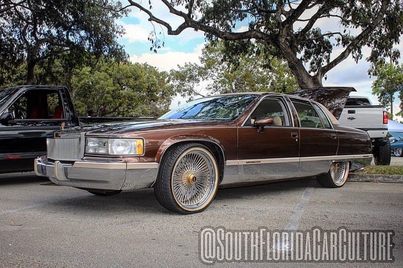 Custom lowrider Cadillac on gold wire wheels by All Out Customs